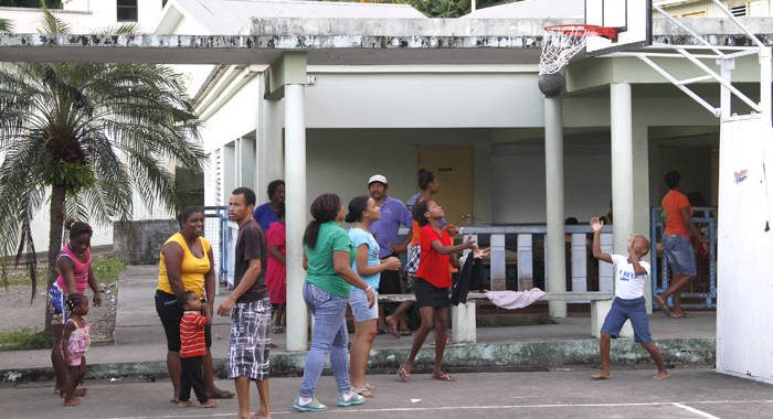 Scores of persons were forced into emergency shelters after their homes were destroyed. Here, some of them play basketball at the Sandy Bay Gov't School on Sunday. (IWN photo)