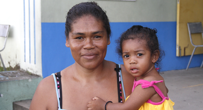 Janetta Hoyte-Collins, seen here with her 18-month-old daughter, survived Hurricane Tomas in the house that the trough system destroyed. (IWN photo)