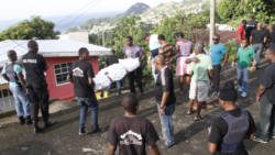 Police suprevise funeral home workers as Neptune's body is removed from the scene. (IWN photo)