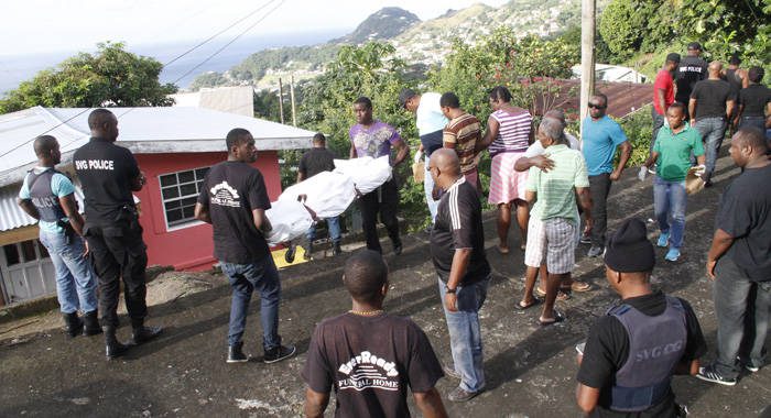 Police suprevise funeral home workers as Neptune's body is removed from the scene. (IWN photo)