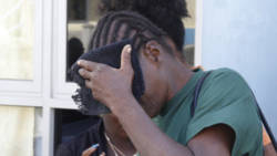Laverne "Fish" Prince hides her face after leaving court on Wednesday. (IWN photo)
