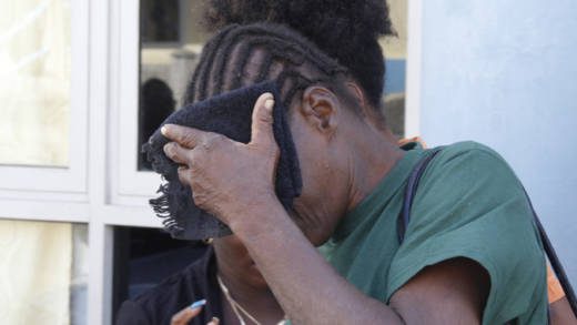 Laverne "Fish" Prince hides her face after leaving court on Wednesday. (IWN photo)