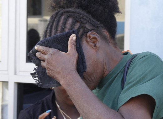 Laverne "Fish" Prince hides her face after leaving court on Wednesday. (IWN photo)
