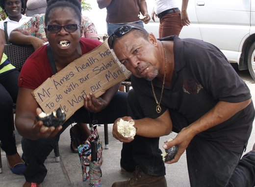 Then-workers at Buccament Bay Resort make their point during a protest over non-payment of wages on Dec. 3, 2016. Opposition Leader Godwin Friday says that the money owed to the workers should be given to them from Harlequin's share of the resort sale deal.  l(IWN photo) 