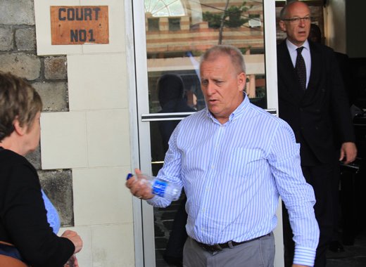 Manager of Harlequin Property, Dave Ames, centre, leaves the High Court in Kingstown on June 22, 2016, where the High Court of England was hearing evidence in a case Harlequin brought against its former accounting firm, Wilkins Kennedy. 