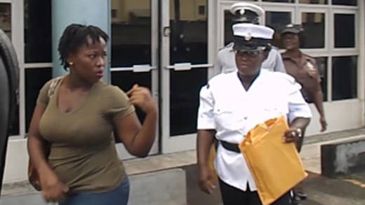 The accused, Latish Williams, leaves the Kingstown Magistrate's Court under police escort.