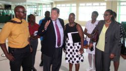 Prime Minister Ralph Gonsalves interacts with persons touring a tour of the terminal building of AIA on Wednesday. (IWN photo)