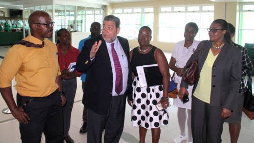 Prime Minister Ralph Gonsalves interacts with persons touring a tour of the terminal building of AIA on Wednesday. (IWN photo)