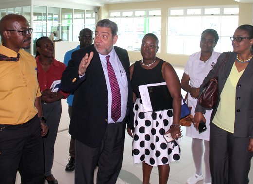 Prime Minister Ralph Gonsalves interacts with persons touring a tour of the terminal building of AIA on Wednesday. (IWN photo)