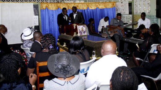 Carianne Padmore's uncle, Hailes Castello, delivers the eulogy at her funeral on Saturday. (iWN photo)