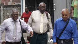 Accused Ehud Myer, centre, former co-accused Colbert Bowens, right, and other persons leave the Serious Offences Court on Monday. (iWN photo)