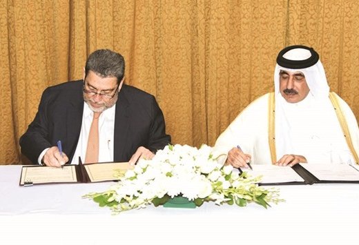 HE Jassim Seif Ahmed al-Sulaiti, left, and Ralph Gonsalves signed an agreement on aerial transport co-operation in Doha yesterday. (Photo: Gulf Times)