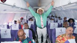 Minister of Tourism, Cecil "Ces" McKie was in quite the celebratory mood on the Caribbean Airlines flight from New York to AIA when the airport opened on on Feb. 14, 2017 (Photo: degrind.com)
