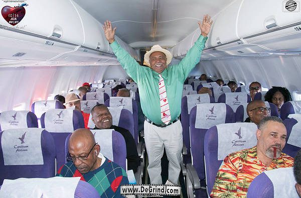 Minister of Tourism, Cecil "Ces" McKie was in quite the celebratory mood on the Caribbean Airlines flight from New York to AIA when the airport opened on on Feb. 14, 2017 (Photo: degrind.com)