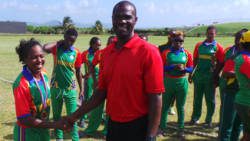 Player of the match, Afy Fletcher, collects medal from third umpire Rayon King.