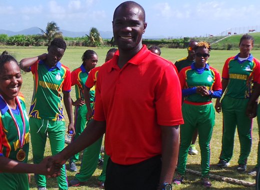 Player of the match, Afy Fletcher, collects medal from third umpire Rayon King.