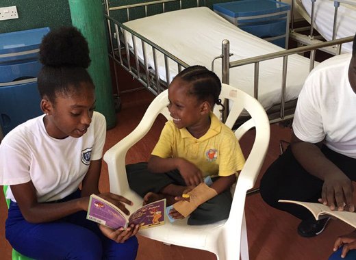 Intermediate High School Young Leaders read to patients at the CHildren's Ward of the Milton Cato Memorial Hospital. 