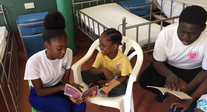 Intermediate High School Young Leaders read to patients at the CHildren's Ward of the Milton Cato Memorial Hospital. 
