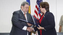 Prime Minister of SVG, Ralph Gonsalves, left, and Political Economic Director at U.S. Embassy in Bridgetown, Yaryna Ferencevyc, signed the agreement in Kingstown. (iWN photo)