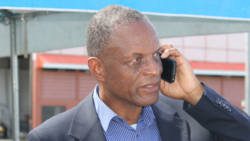Then-President of the SVG Football Federation, Venold Coombs speaks on his cellphone at a football event in Kingstown in April 2017. 
 FIFA on Tuesday banned him from all football-related activities  administrative, sports or otherwise  for two years and fined him US$40,000 (iWN photo)