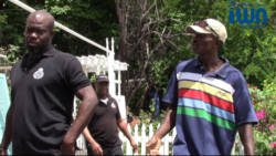 Otis Lockhart chats at his property on Friday with the police officers who arrested him on Monday. (iWN photo)