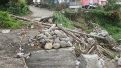 The badly damaged main road is the same 6 months later.