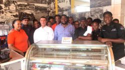 Jaimason Samuel, in blue, and the staff of Manna on opening day on June 1, 2017. (iWN photo)