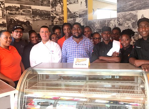 Jaimason Samuel, in blue, and the staff of Manna on opening day on June 1, 2017. (iWN photo)