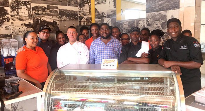 Jaimason Samuel, in blue, and the staff of Manna on opening day on June 1, 2017. (iWN photo)