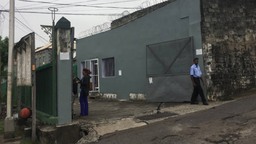 A warden, right, stands outside Her Majesty's Prisons in June. A prisoner underwent emergency surgery after being stabbed there on Monday. (iWN photo)