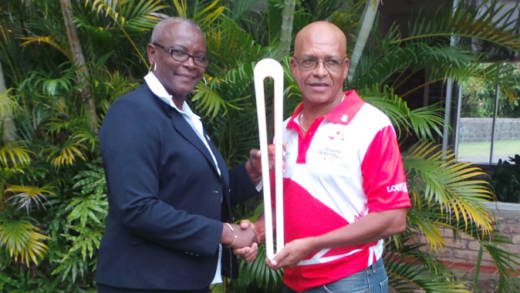 St. Lucia Sen. Fortuna Belrose, hands over the baton to NOC Chairman, Trevor Bailey.