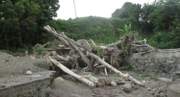 Section of the main road badly damaged with a lot of debris the same as it was 6 months ago