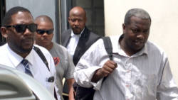 Charles, right, accompanied by Duncan, left, another detective, and his lawyer, leaves the court on Monday. (iWN photo)
