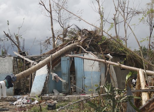 A poorly constructed house in Gelée, Les Cayes, Haiti is further damaged by trees that fell during the passage of Hurricane Matthew in October 2016. A senior Caribbean diplomat assigned to the European Union says climate change events are preventing many Caribbean countries from moving up the development ladder. Credit: Kenton X. Chance/IPS