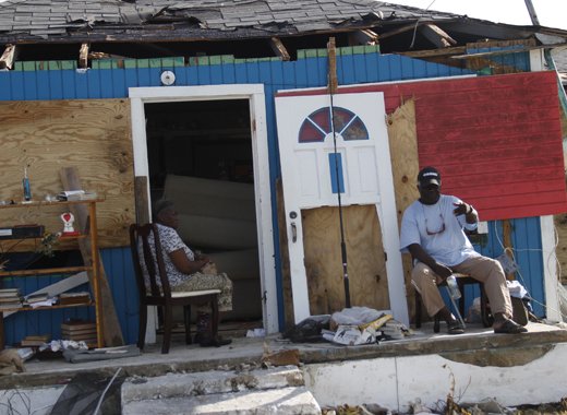 People wait for assistance after the devastation left by Hurricane Matthew in Low Sound, North Andros, The Bahamas in October 2016. A leading climate change mitigation and adaptation activist in the Caribbean says more climate-related disasters can result in climate refugees looking towards the United States for assistance. Credit: Kenton X. Chance/IPS