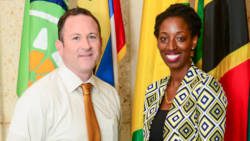 Jeon Adams-Julien, right, poses with Deputy Public Affairs Officer Jeff Barrus before departing on the U.S. Department of States International Visitor Leadership Program.