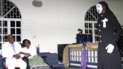 Dr. George and Elsie Frederick watch as Samantha Diamond performs a tribute to them on Sunday. (iWN photo)