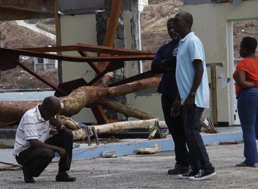 Commissioner of Customs Aubrey Forbes stoops after surveying the damage at the Jost Van Dyke ferry terminal in West End Tortola. CMC photo.jpg
