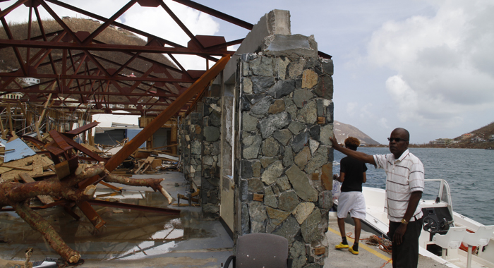 Commissioner of Customs Aubrey Forbes surveys the damage at the Jost Van Dyke ferry terminal in West End Tortola. CMC photo