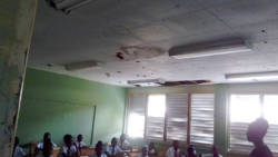 Students sit in a mouldy classroom at Bethel High School during orientation on Thursday.