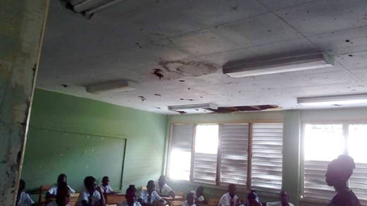 Students sit in a mouldy classroom at Bethel High School during orientation on Thursday.