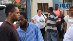 Inether Bailey-Holder, background centre, and other person look as Primus, left, who is accused of killing her daughter, is led back to prison on Friday. (iWN photo)