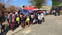 Persons queue outside the deep water harbour on Roseau on Thursday hoping for an opportunity to leave storm ravaged Dominica. CMC photo