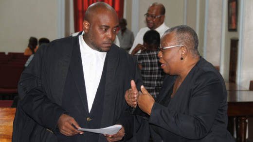 Supervisor of Elections Sylvia Findlay-Scrubb, right, speaks with Kenny Kentish, one of her lawyers, at the High Court on Tuesday. (iWN photo)