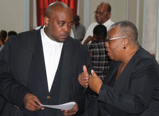 Supervisor of Elections Sylvia Findlay-Scrubb, right, speaks with Kenny Kentish, one of her lawyers, at the High Court on Tuesday. (iWN photo)