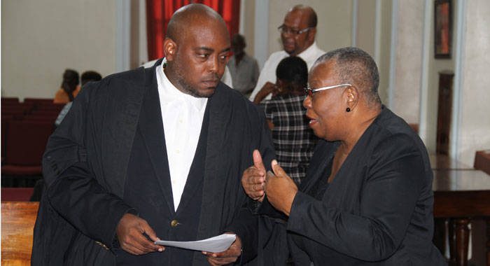 Supervisor of Elections Sylvia Findlay-Scrubb, right, speaks with Kenny Kentish, one of her lawyers, at the High Court on Tuesday. (iWN photo)