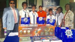 GHS principal, Michelle Beache (far right), supervising/physics teacher Lenski Adams (centre), and the winning team, accept prize bags from Public Affairs Officer James Rodriguez (far left).