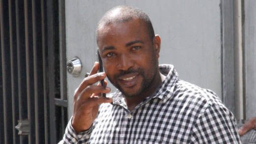 The defendant, Allan Gibson, speaks on his mobile phone after his trial on Wednesday. (iWN photo)