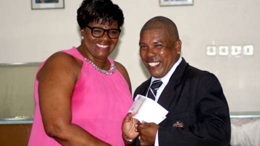 Superintendent of Police Ruth Jacobs presents a check to Assistant Superintendent of Police Hesran Ballantyne at last week's event.