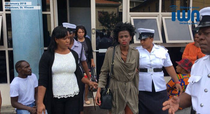 Former model, Yugge Farrel, is escorted from the Kingstown Magistrate Court for transportation to the Mental Health Centre on Monday. (iWN image)